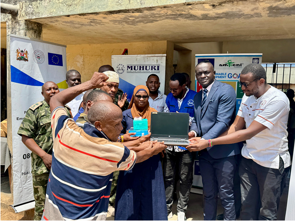 NLAS staff donating laptops to marginalized persons in prison to enable them attend virtual court sessions